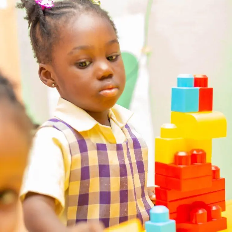 An Early Years pupil concentrating on a building activity