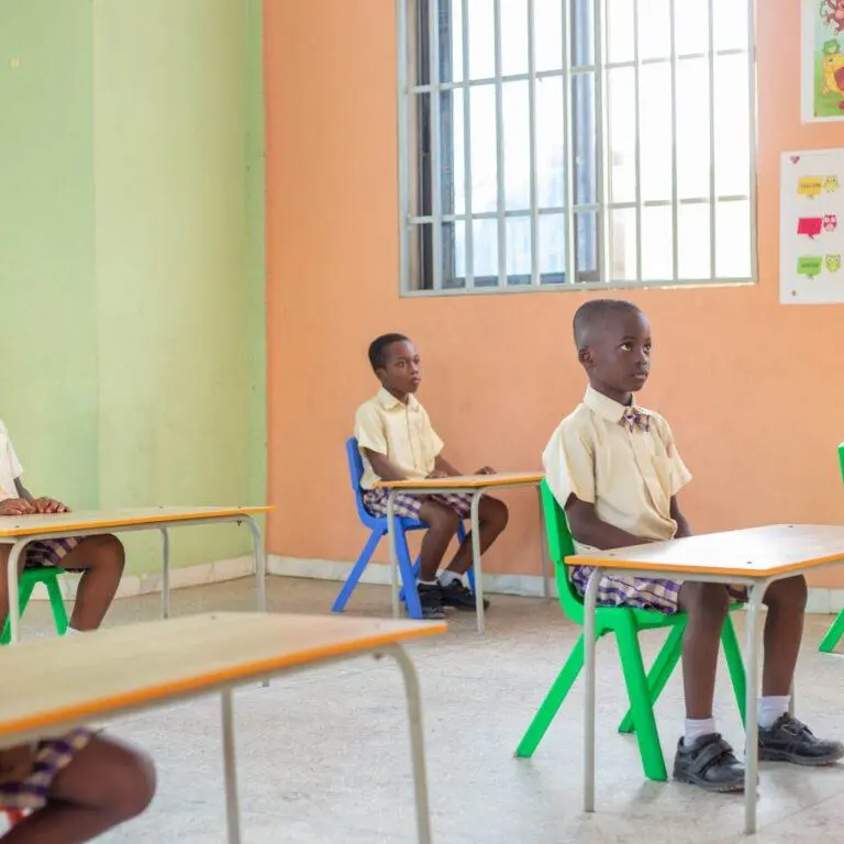 Pupils working quietly at their desks in a bright classroom