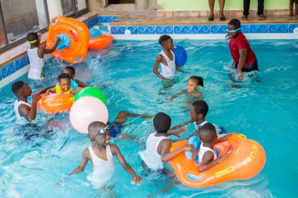 Pupils playing with floats in the swimming pool